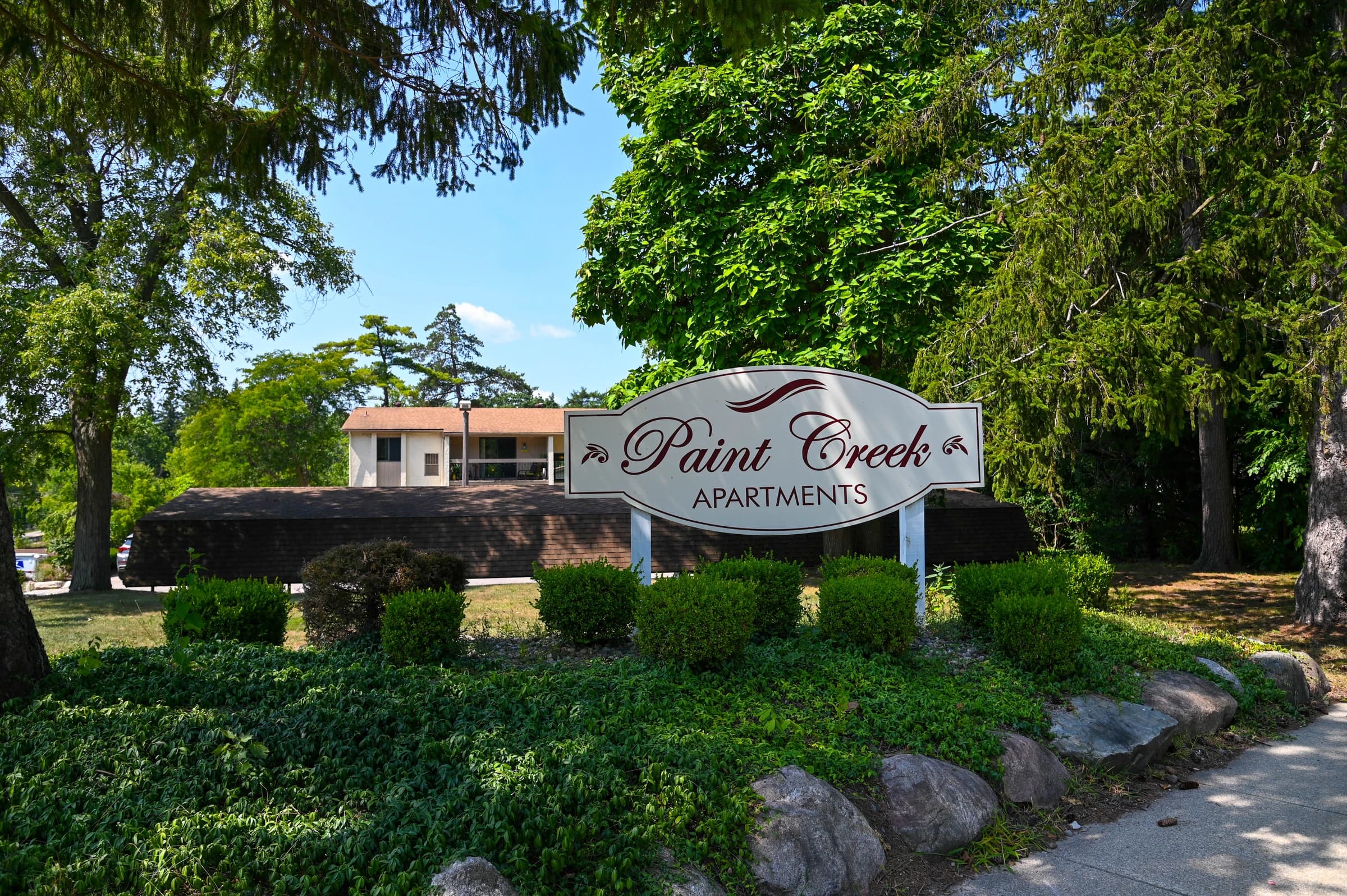 Paint Creek Apartments entrance surrounded by mature trees